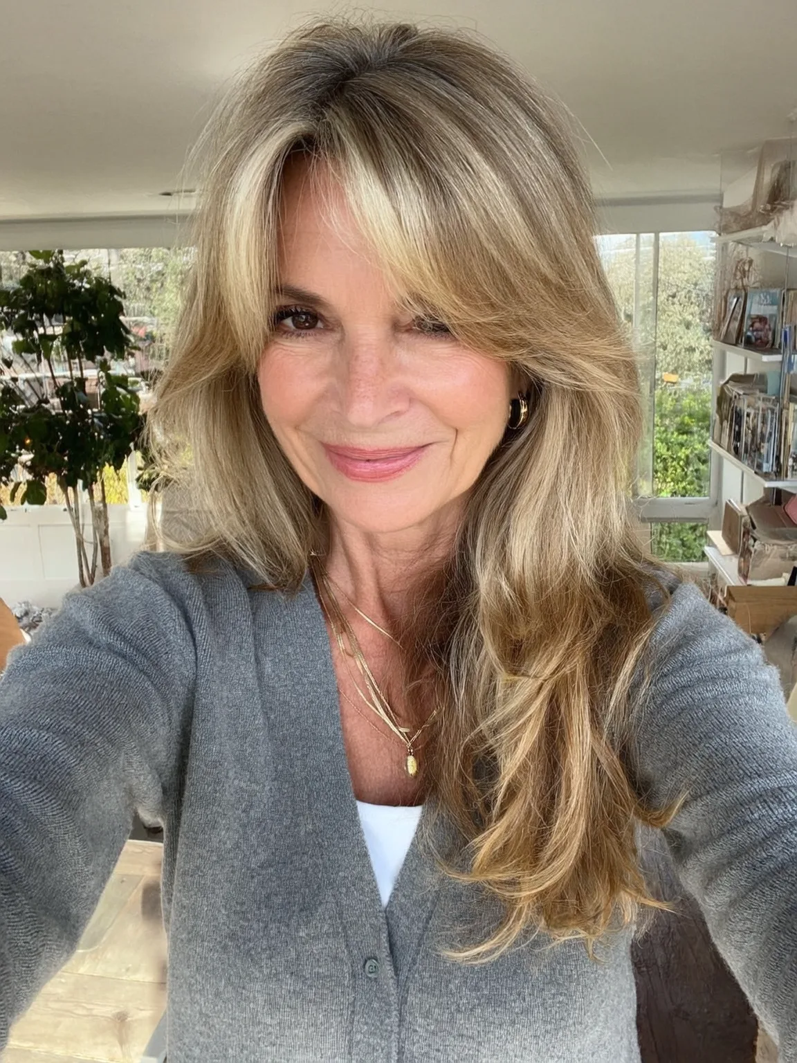 Wavy Sandy Blonde Layers with Curtain Bangs for Oval Faces